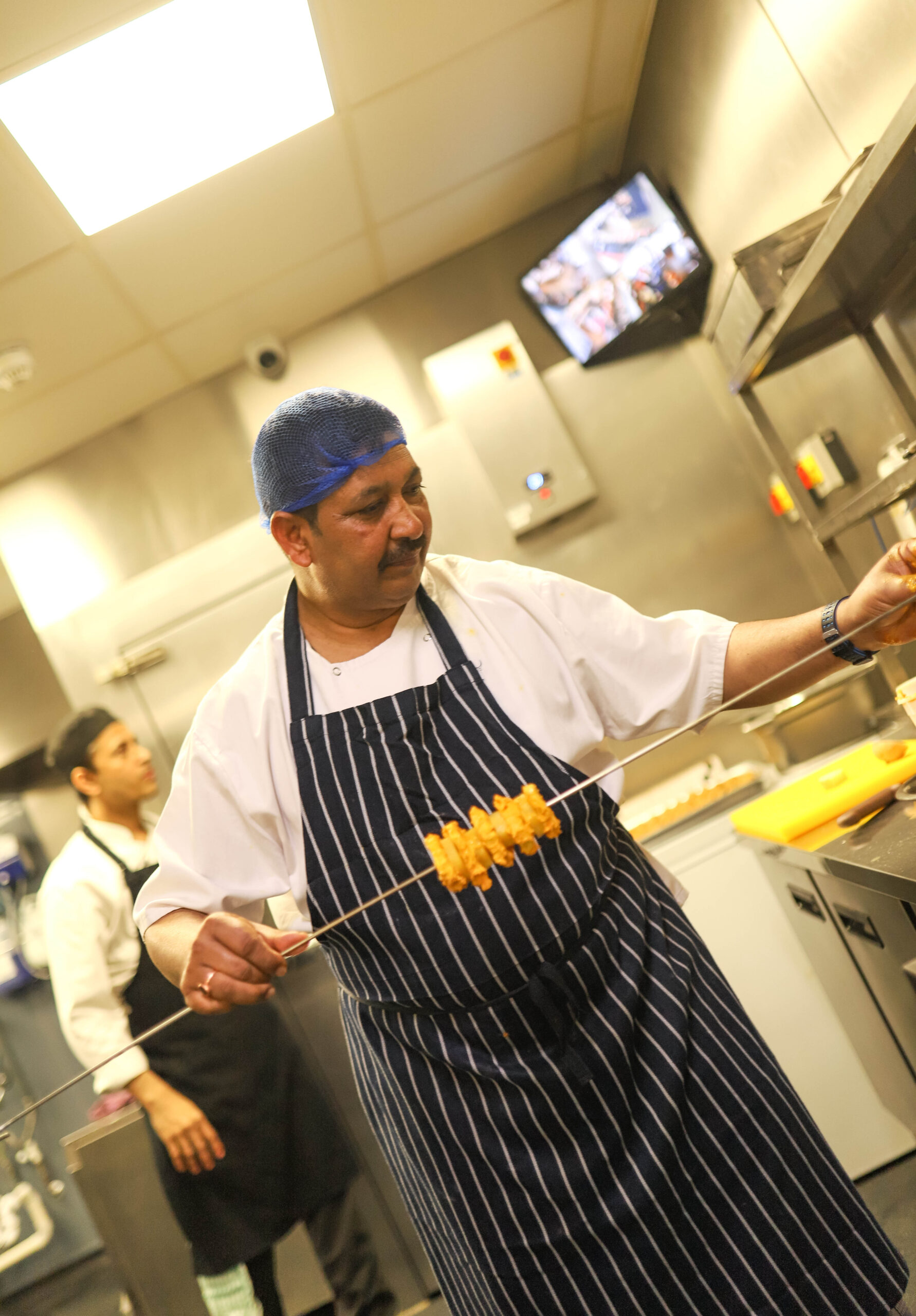 A chef crafting an Indian dish in Orpington